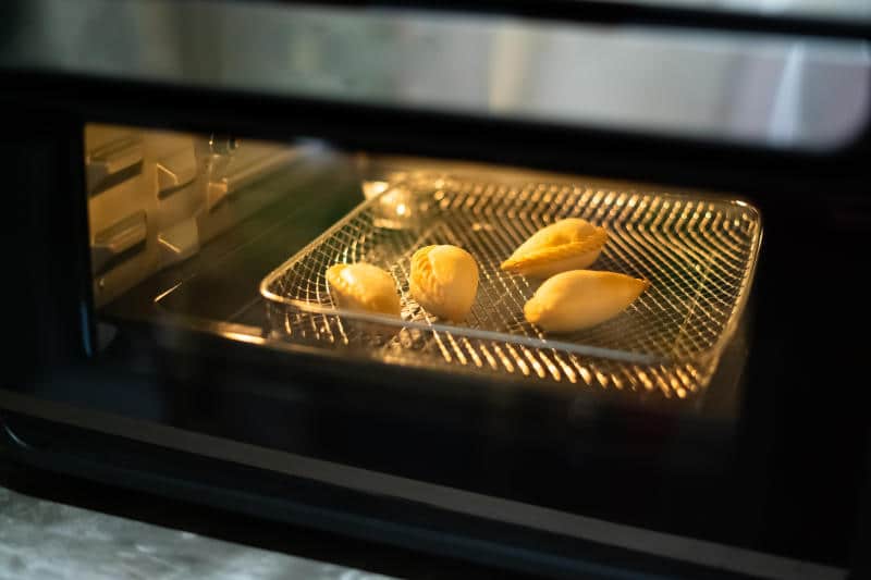 Air fryer oven is cooking food in the kitchen