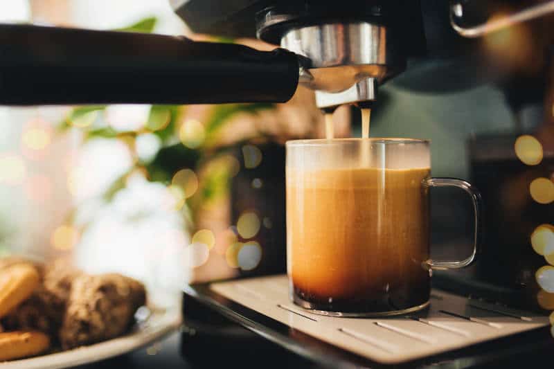 Cup of coffee at the coffee maker, coffee time.