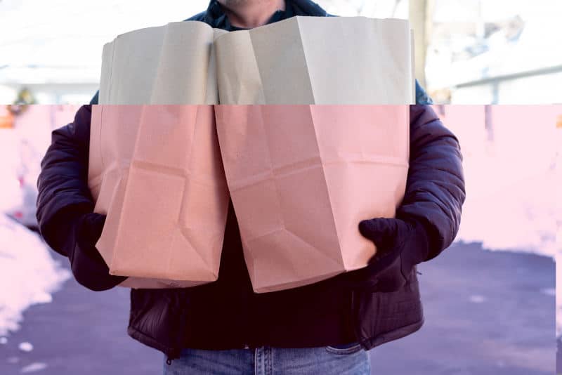 Man carrying paper grocery bags