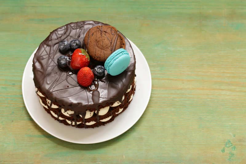 Decorated chocolate cake on board