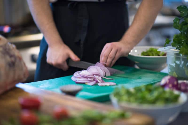 Chef Cutting Onion With Knife 