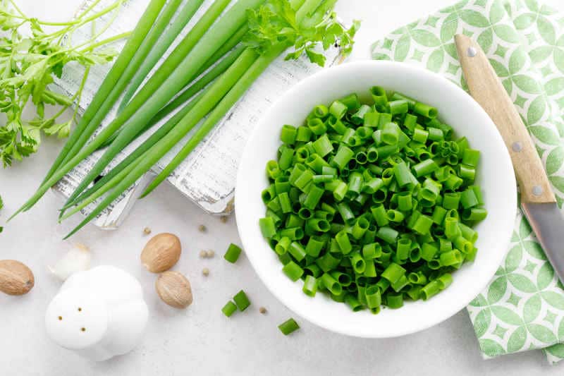 Fresh green onion sliced in bowl