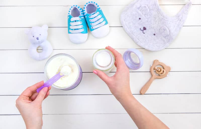 Baby bottle with milk on white background.