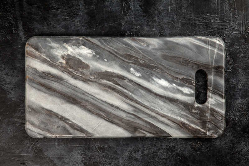 Marble cutting board on black background