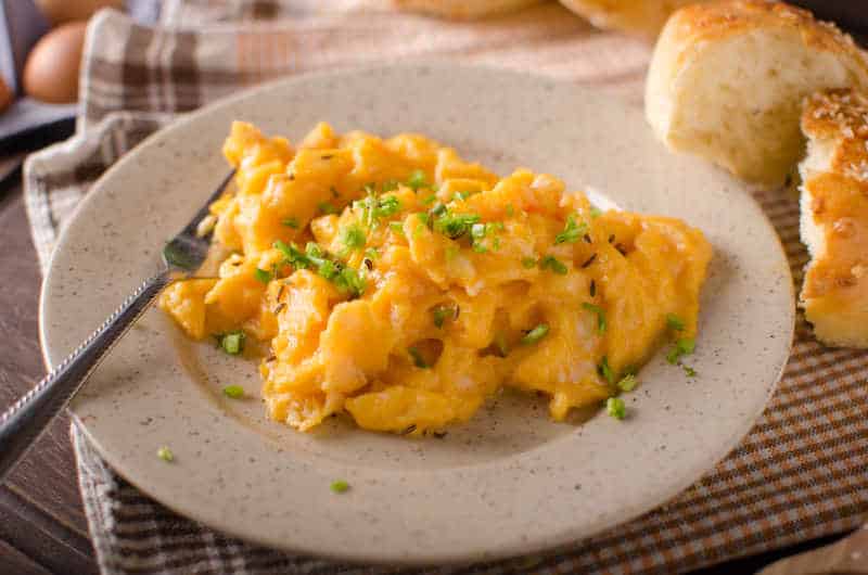 Scrambled eggs with buns, herbs inside, fast and delicious breakfast