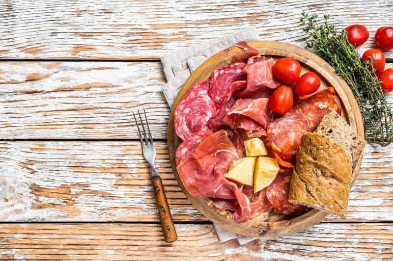 Cold meat plate, charcuterie traditional Spanish tapas on a wooden board