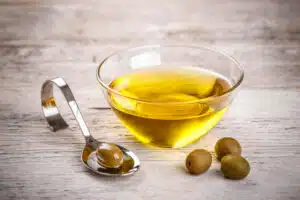 Olives and olive oil on a wooden table