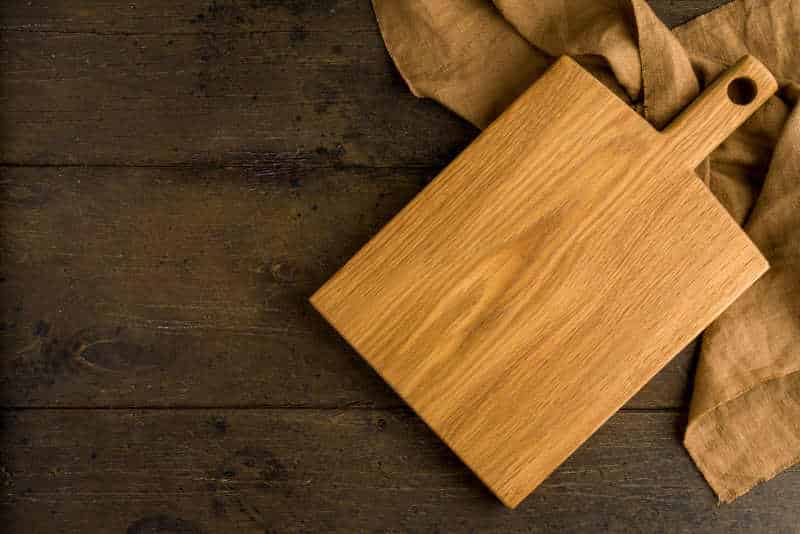 Wooden sturdy surface to prep on. Utensil for cooking food. Linen napkin. Oak chopping trivet.