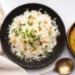 Garlic Fried Rice & Lahsun, served with Dal Tadka over moody background