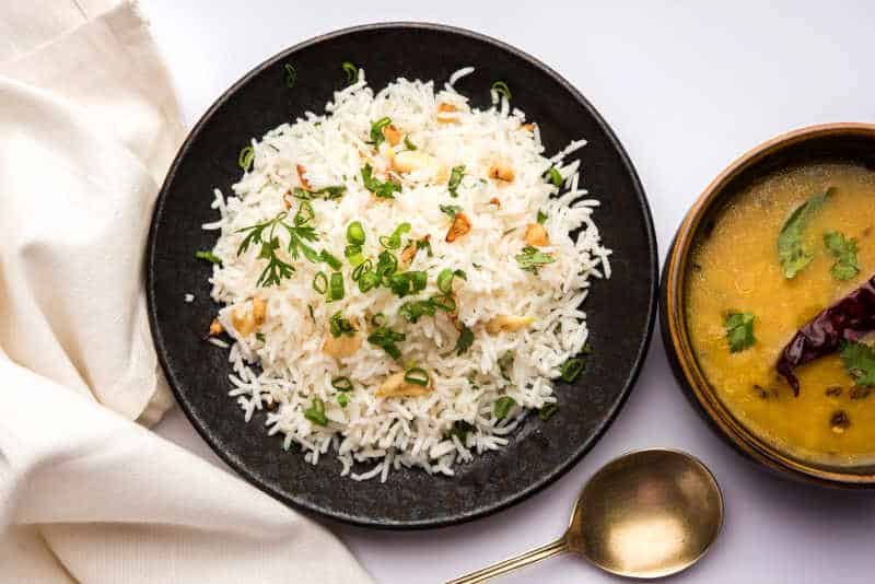 Garlic Fried Rice & Lahsun, served with Dal Tadka over moody background