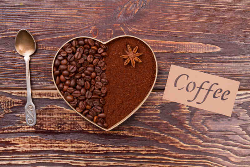 Decorative heart made of coffee beans and instant coffee powder