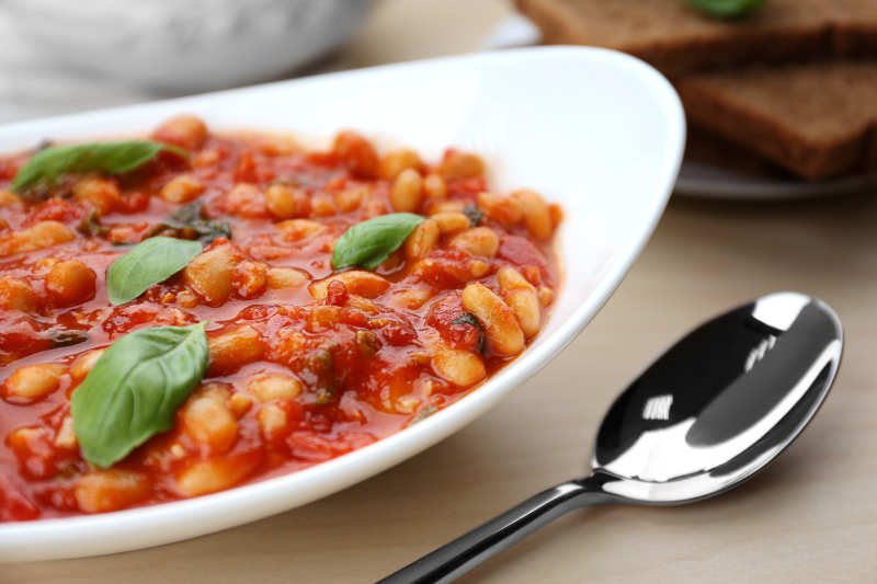 Plate with delicious Italian butter beans and spoon