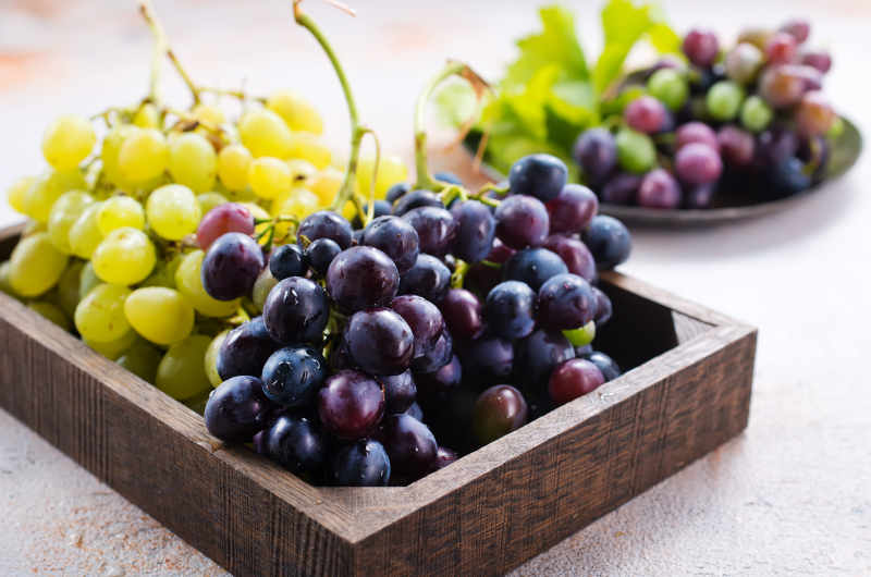 Black and green grapes on a table