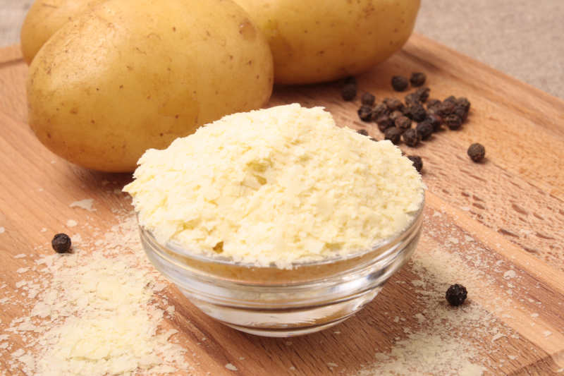 Instant potatoes and pepper on the wooden board