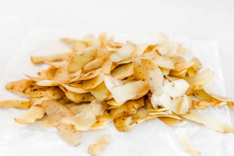 Potato skins peeled on kitchen table