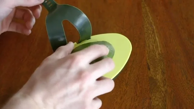 Placing avocado halves in a avocado saver