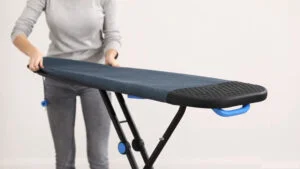 Setting ironing board cover on a ironing board